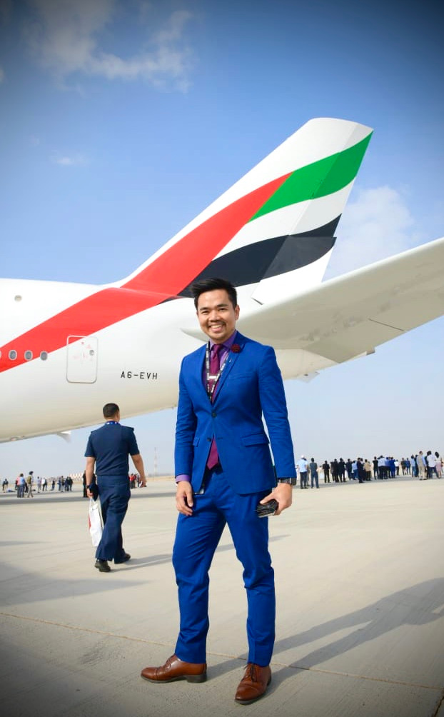 Joseph Alcantara on site beside an Emirates aircraft
